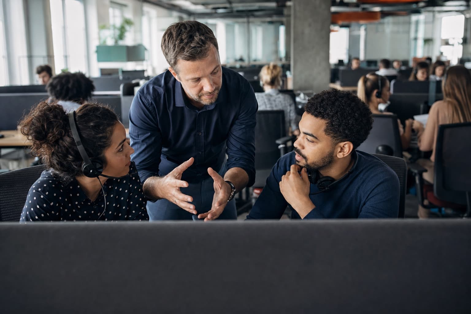 A frontline manager helping a customer service team solve recurring problems